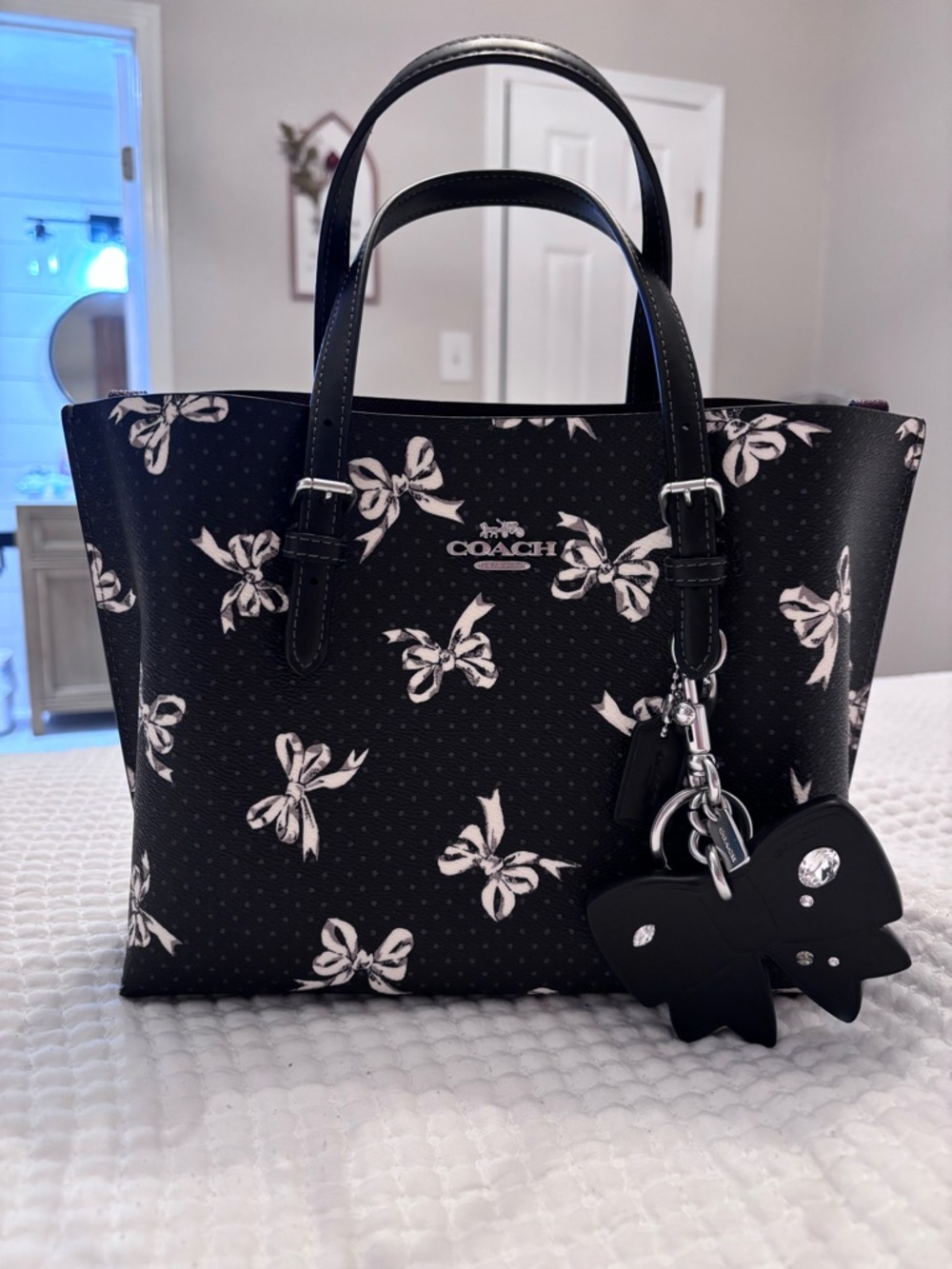 Never used! Coach Black Tote with White Bow Print and Charm